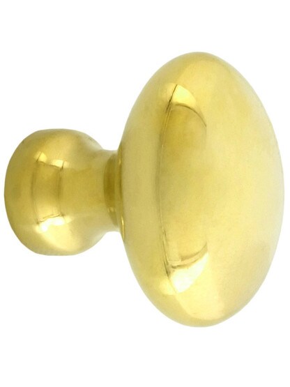 Small Oval Brass Cabinet Knob - 1 inch x 5/8 inch in Unlacquered Brass.